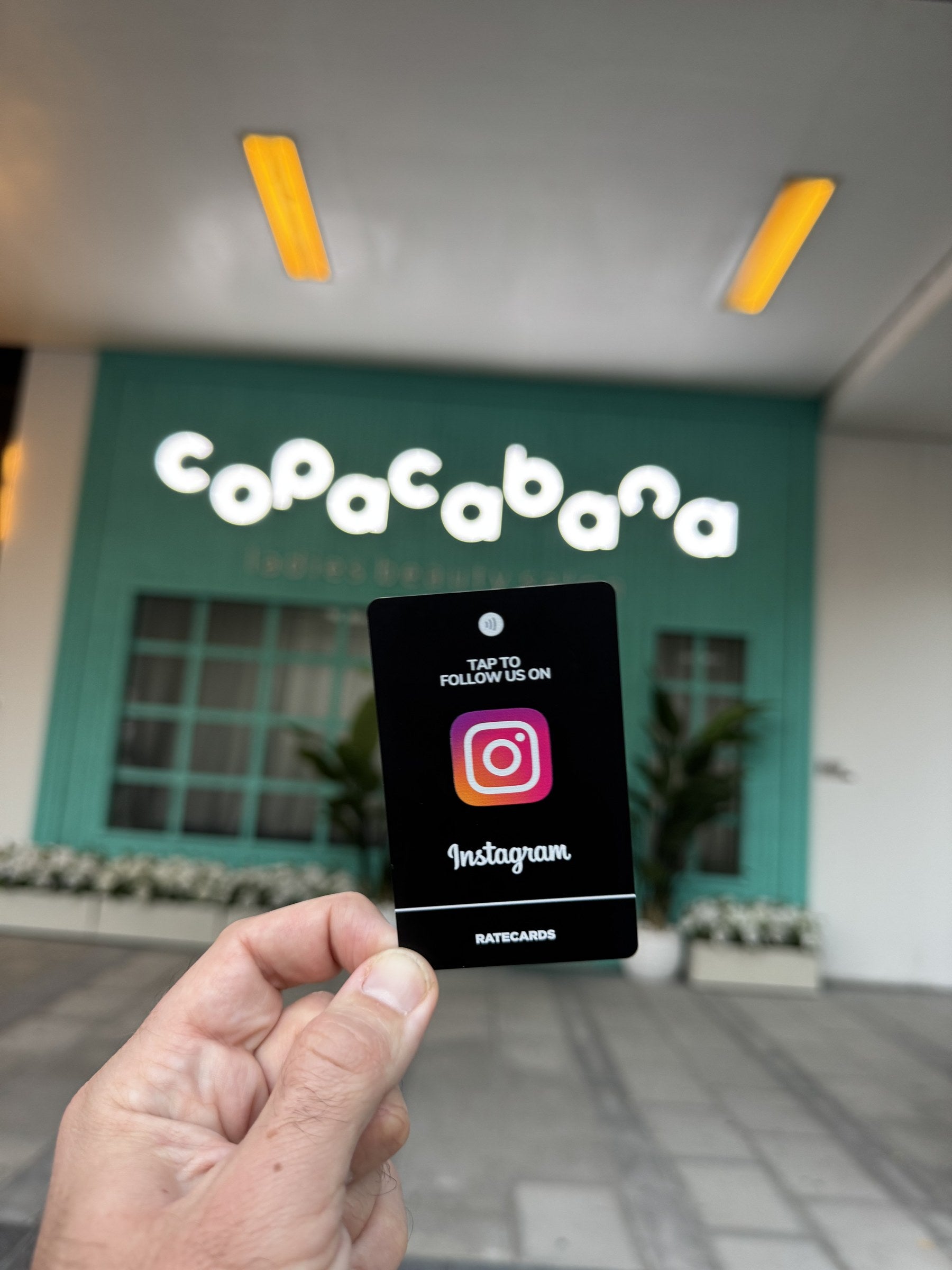 RATECARDS Instagram Card Premium Black in use at Copacabana cafe - tap to follow at the entrance