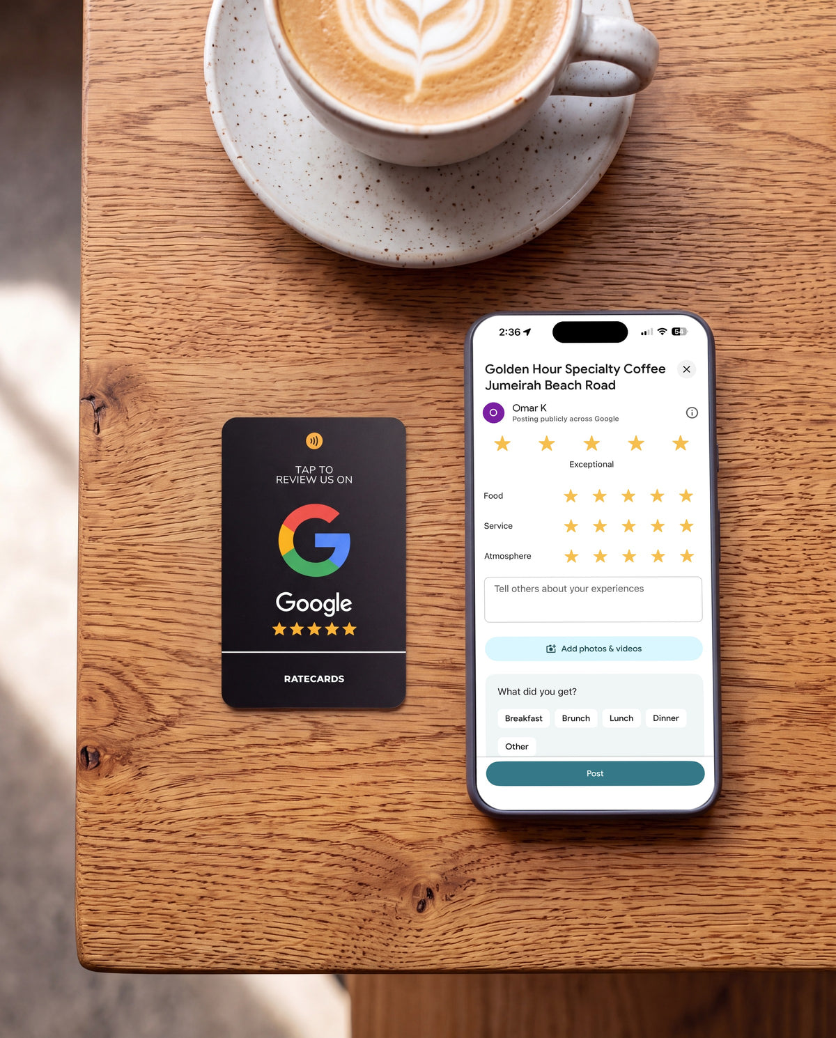 RATECARDS Google Review Card Premium Black on a café table with a phone