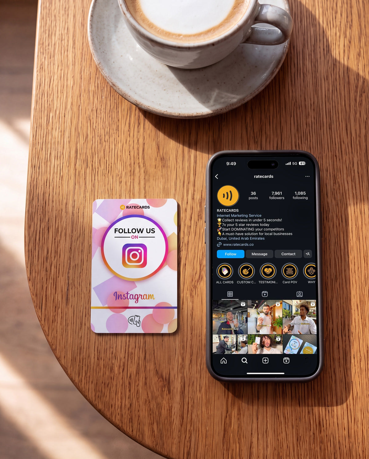 RATECARDS Instagram Card on a café table, phone showing the Instagram profile
