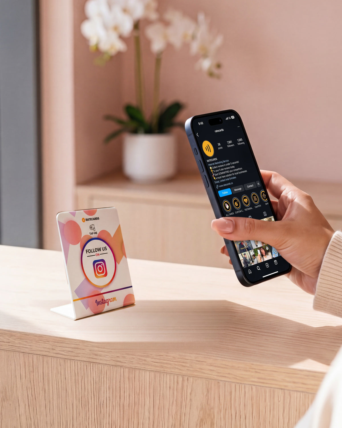 RATECARDS Instagram Followers Stand on a nail-salon reception desk, phone showing the Instagram profile